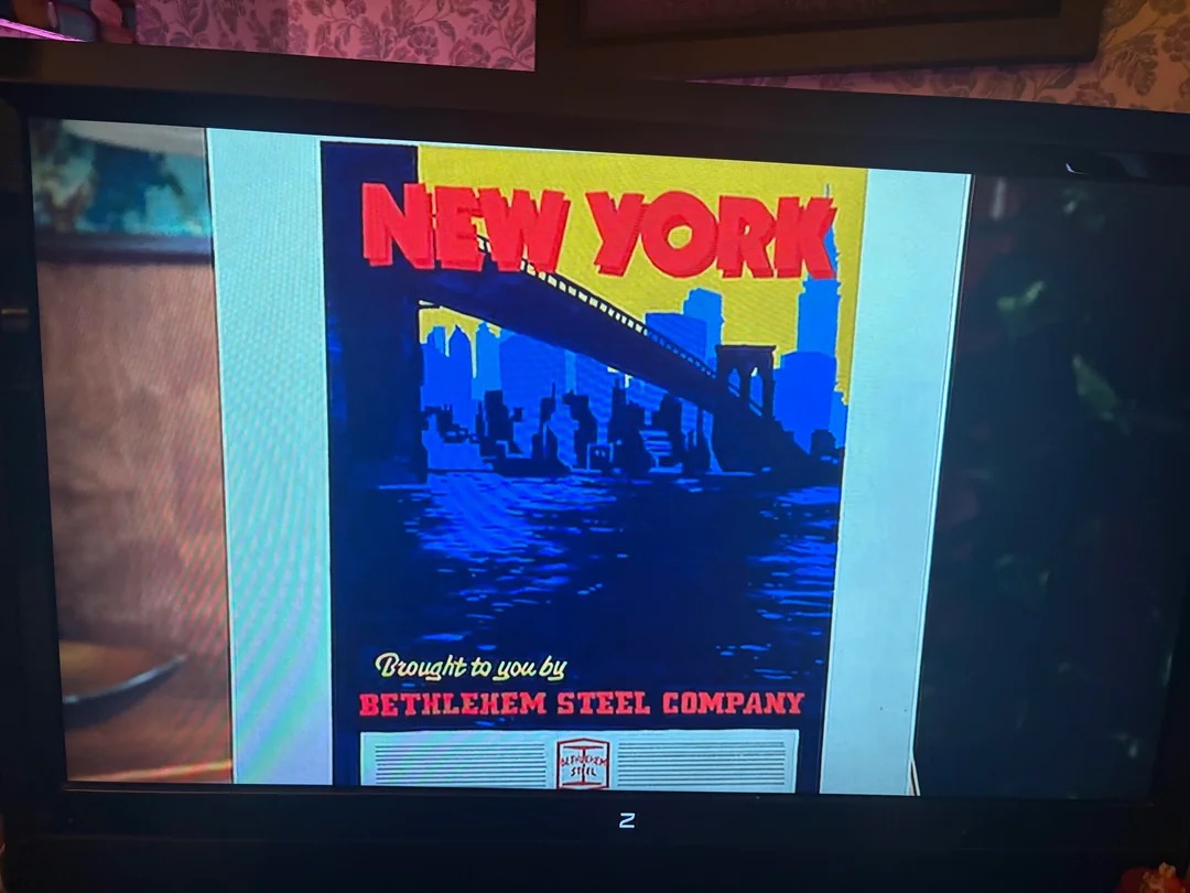 Don Draper presents a New York campaign board reading Brought to you by Bethlehem Steel Company in the Mad Men episode New Amsterdam
