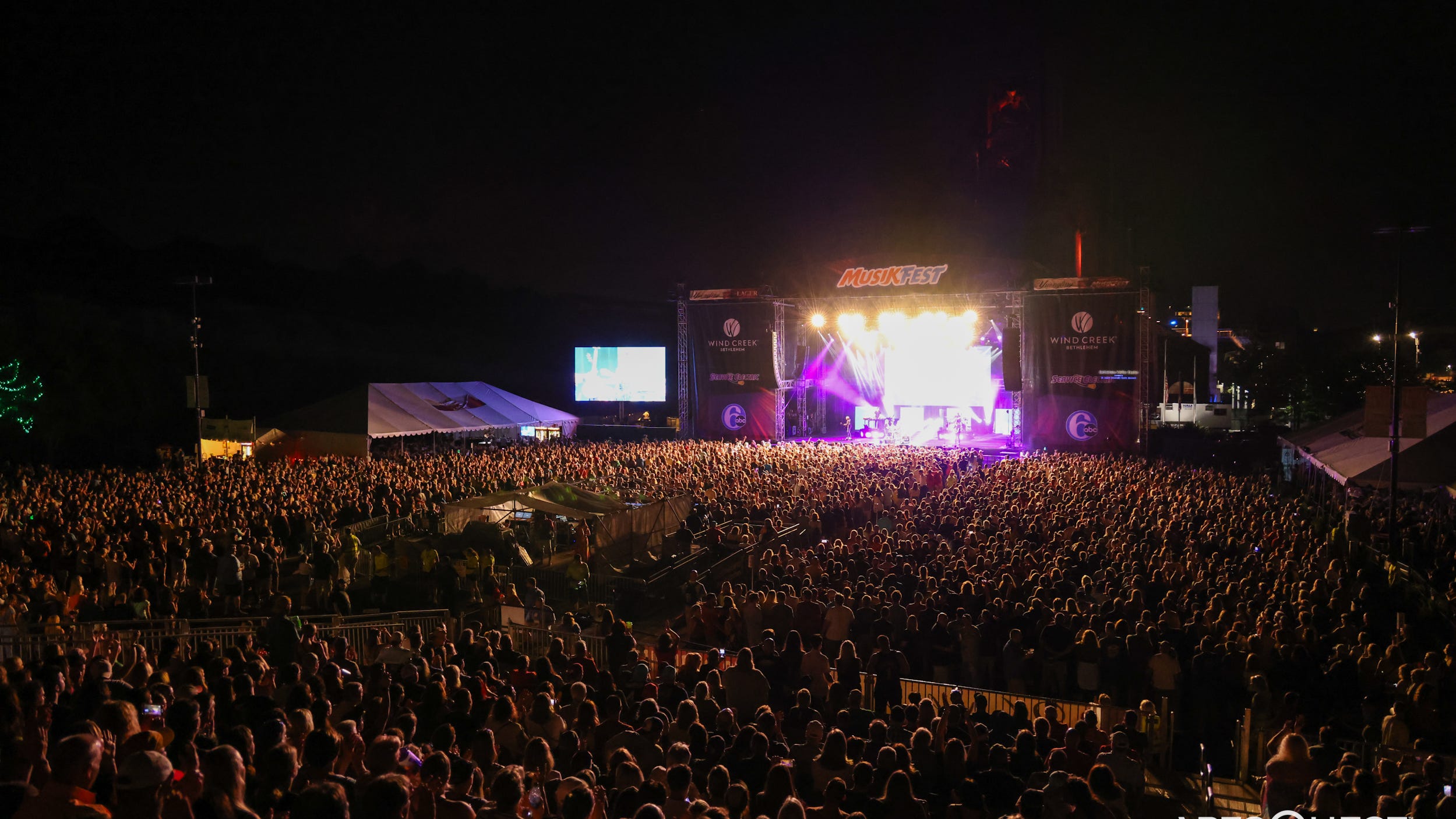 A large nighttime crowd in front of a lit Musikfest stage in Bethlehem