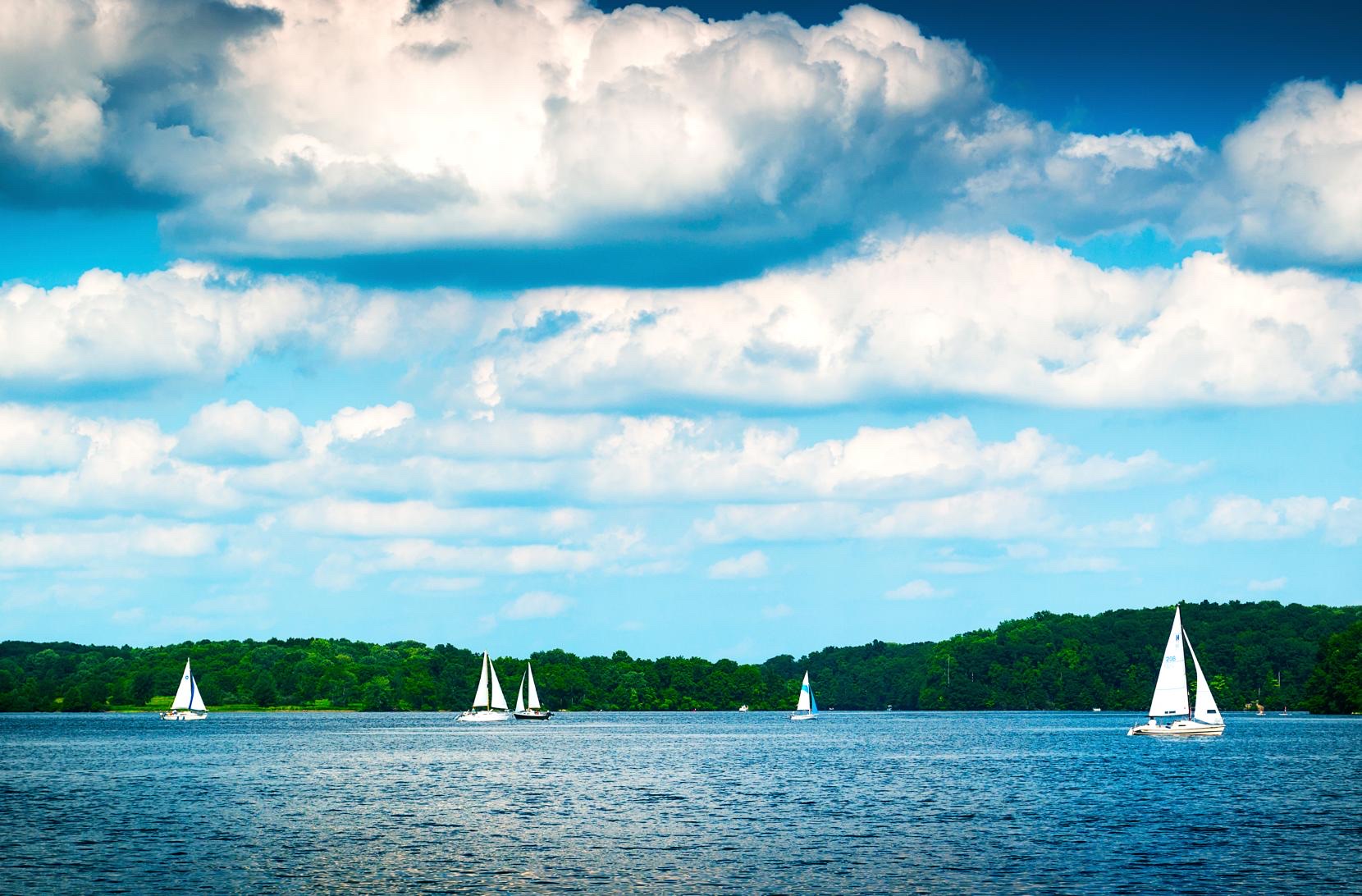 Sailboats on Lake Nockamixon under a cloudy summer sky