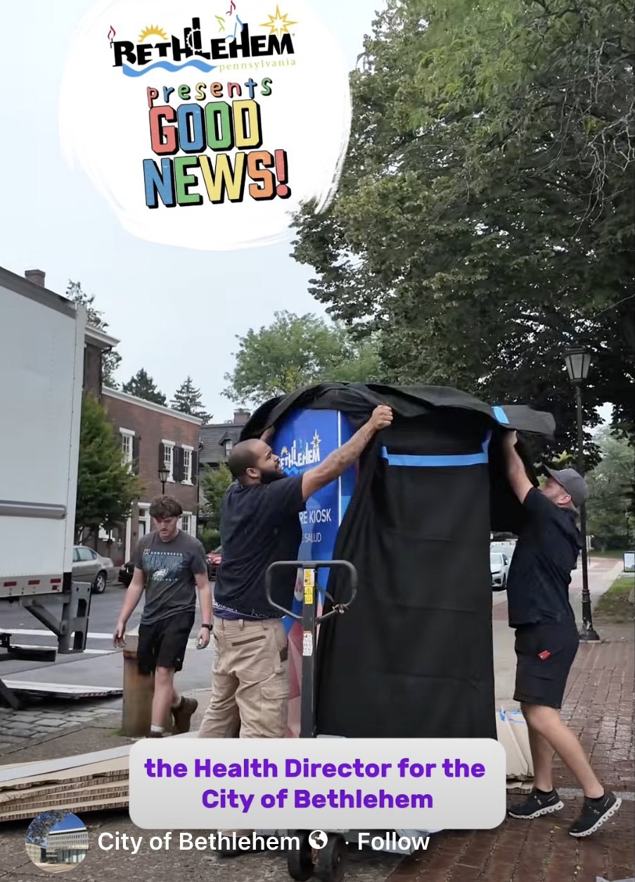 City workers uncrate a healthcare kiosk