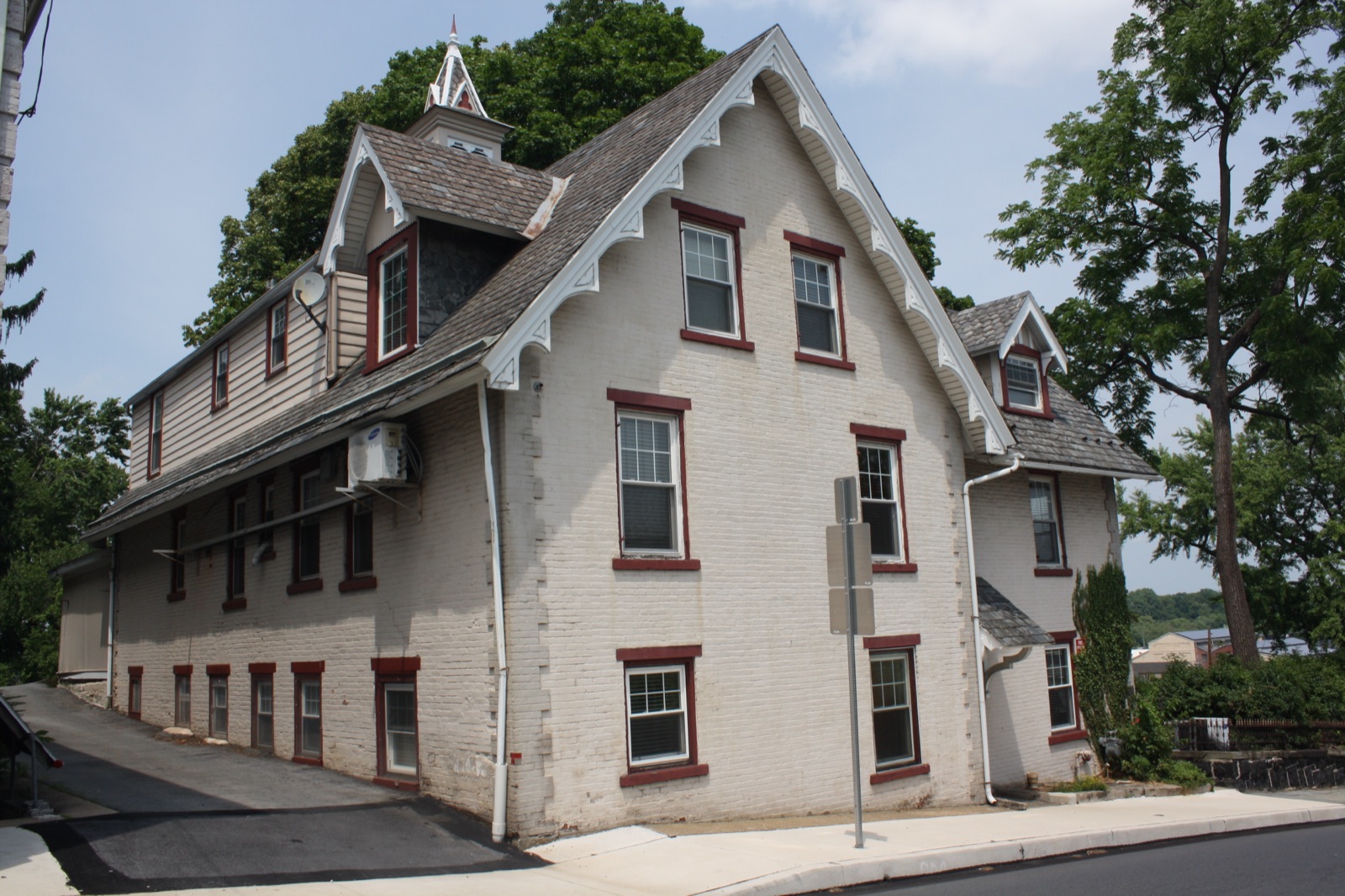 431 West Third Street, a painted brick Gothic Revival house with elaborate sawn bargeboard trim and a small spired cupola