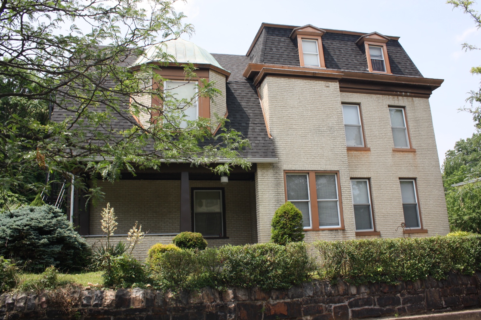 501 Seneca Street, a cream brick Second Empire house with a mansard roof and a copper-domed bay
