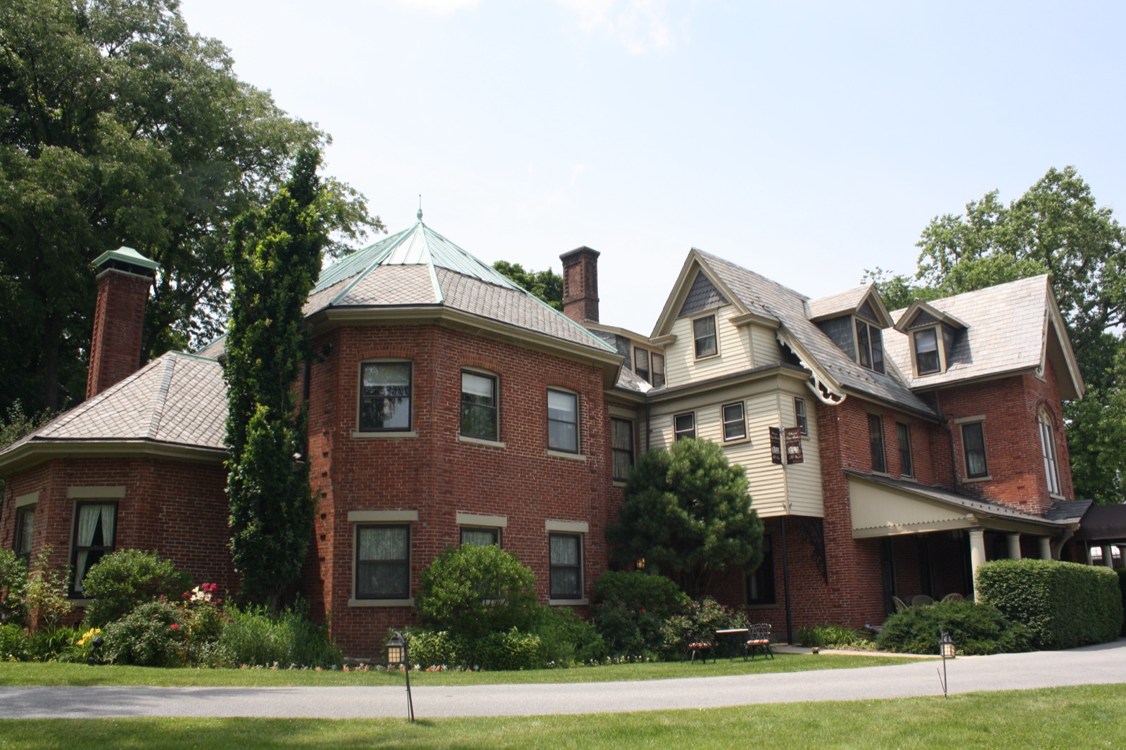 The Sayre Mansion, a red brick Victorian with an octagonal tower and copper roof, in the Fountain Hill Historic District