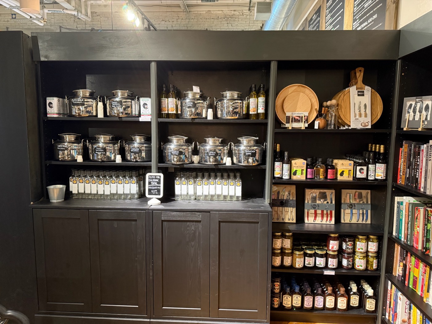Olive oil and balsamic bar with cheese knives and cookbooks