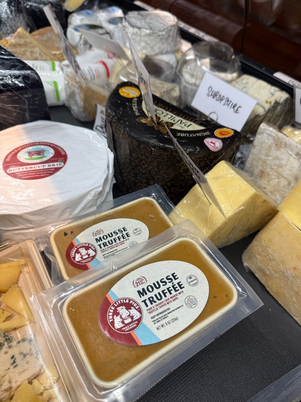 Close-up of cheeses including Buttercup Brie and Papillon Roquefort