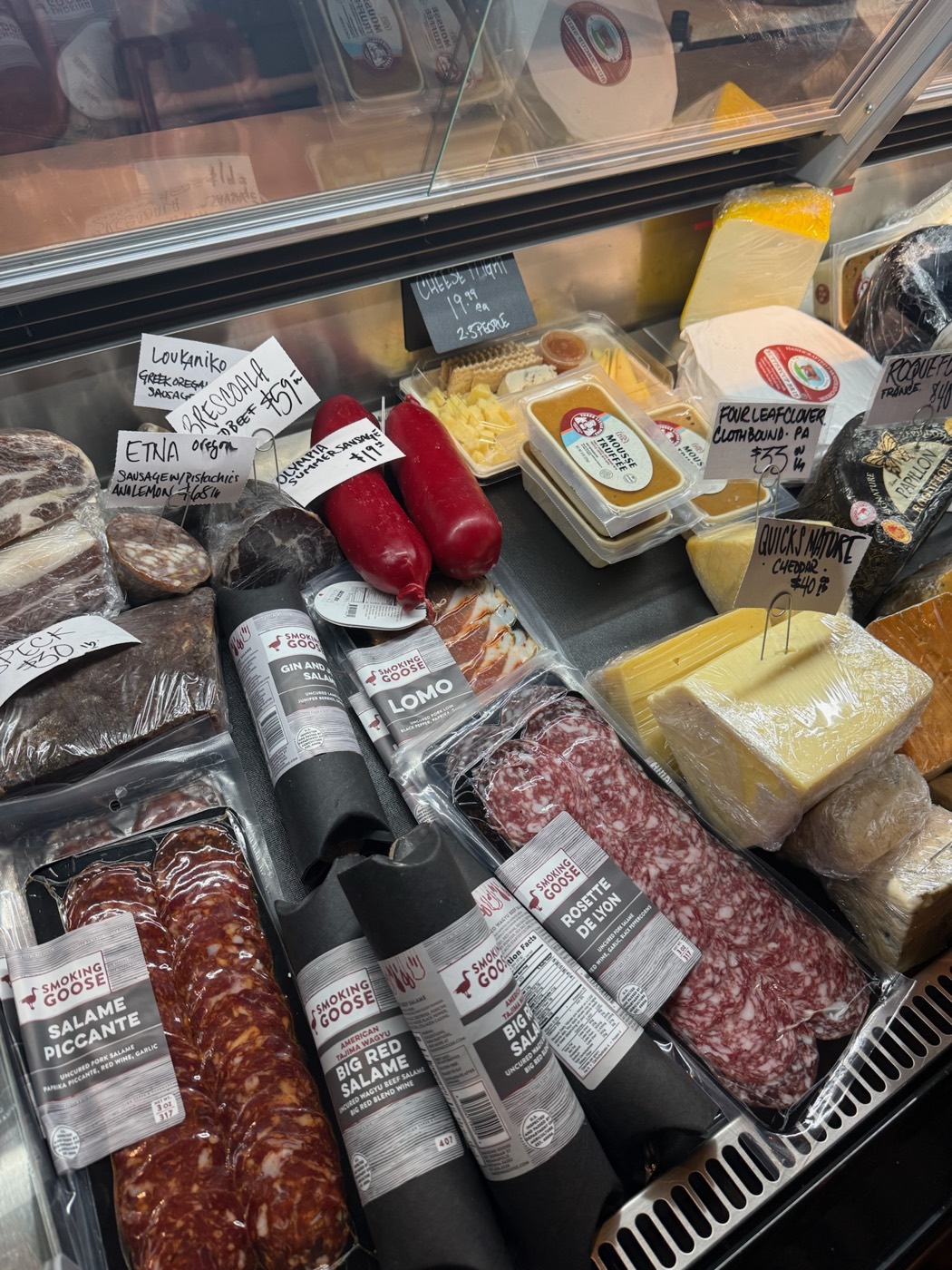 Charcuterie case with cured meats and salami