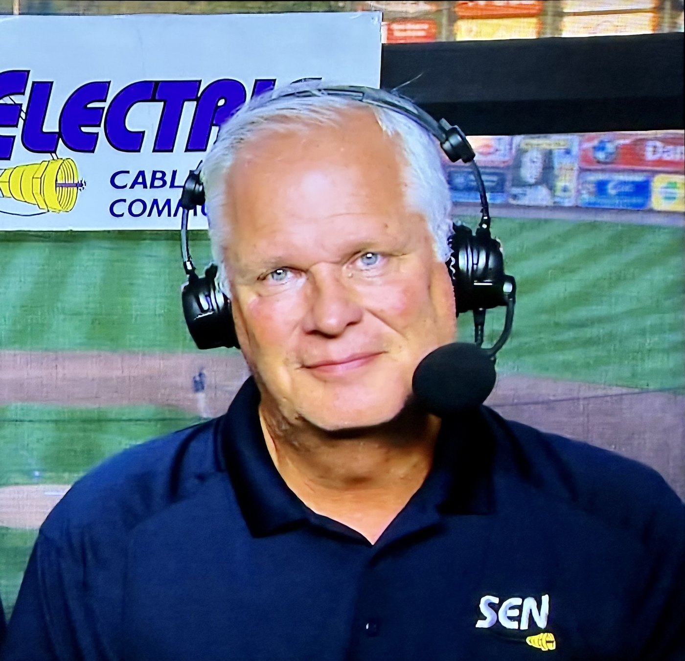 Tim Neiman wearing a broadcast headset in the Service Electric booth at an IronPigs game