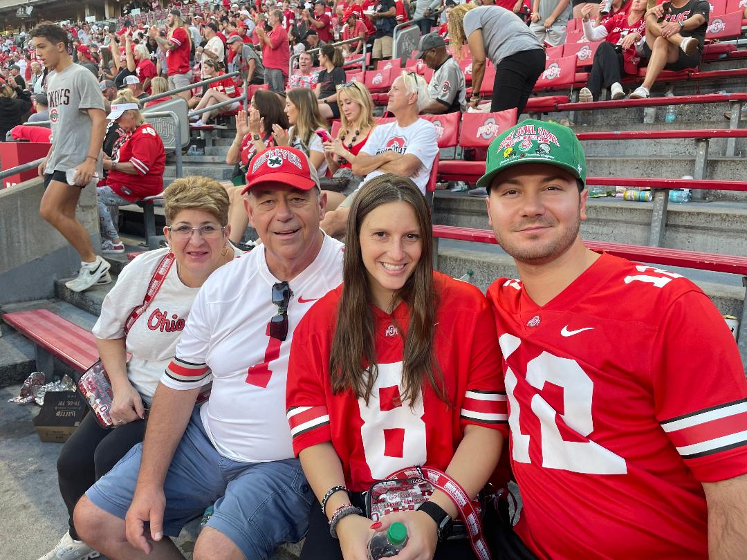 Ron and Sandy Serafin with their son Anthony and his fiancee Claudia in Ohio State gear in the stands at a Buckeyes game