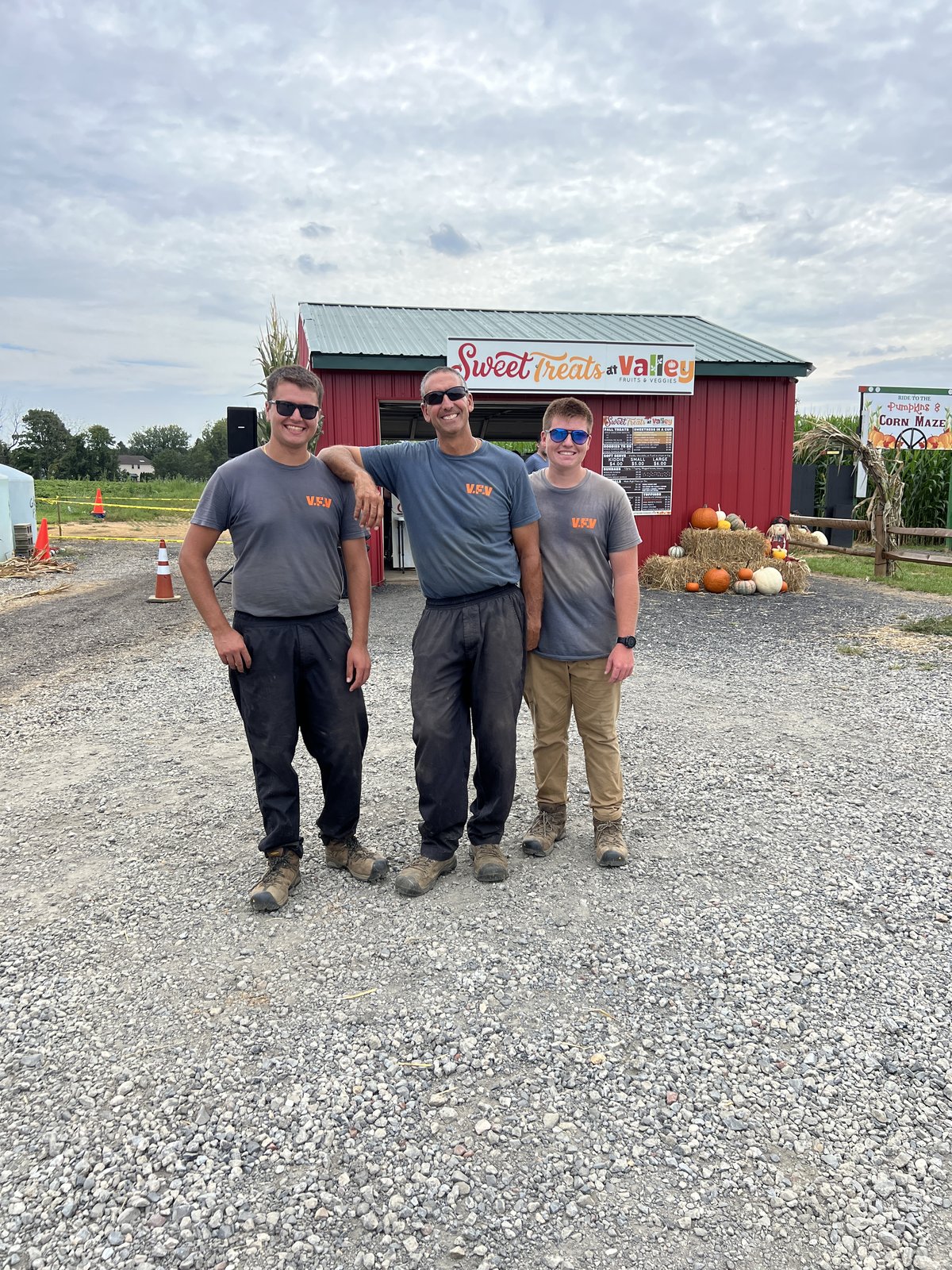 Three members of the Valley Fruits and Veggies crew outside the Sweet Treats stand